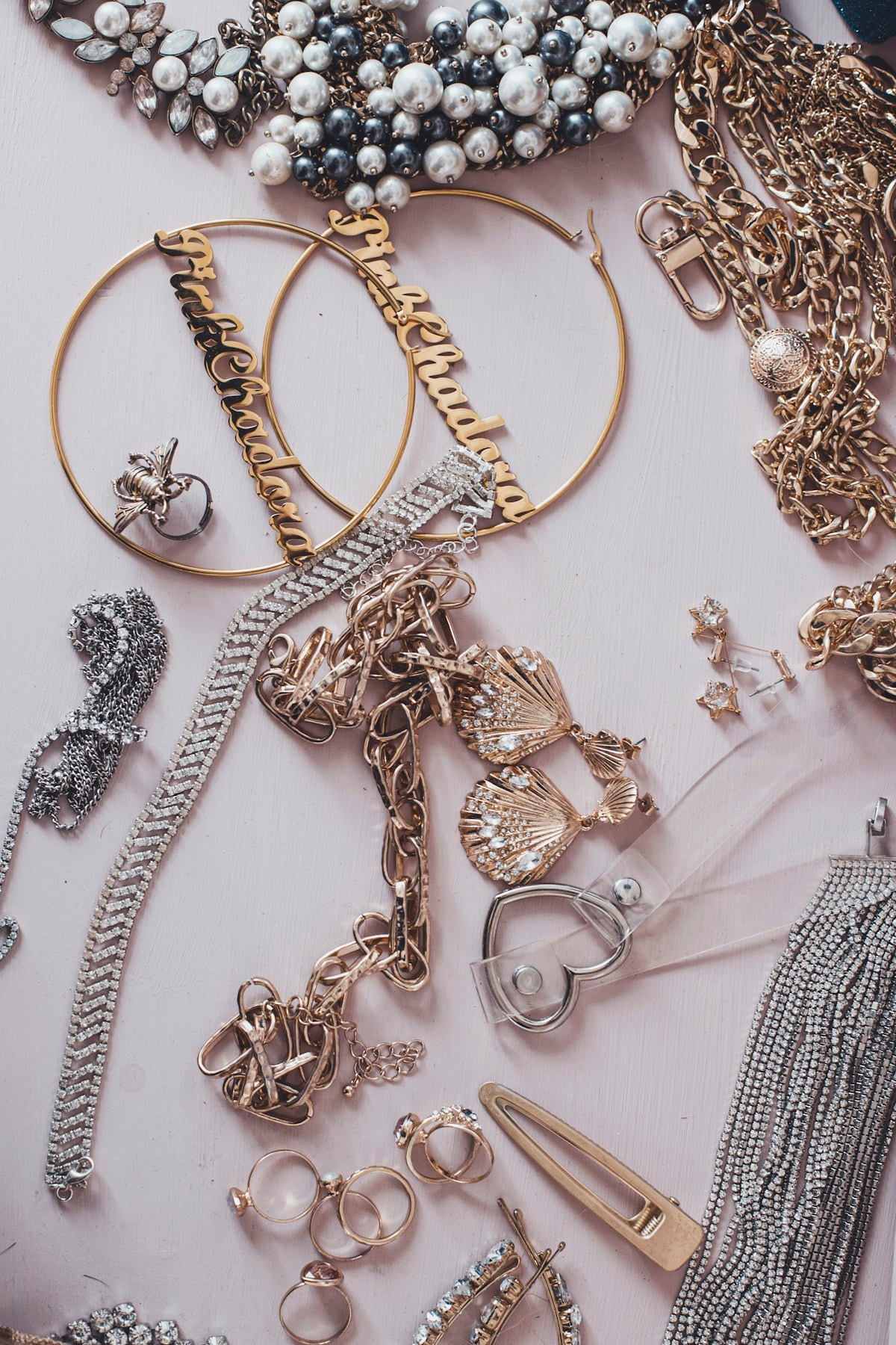 A collection of gold and silver jewelry including necklaces, earrings, and rings