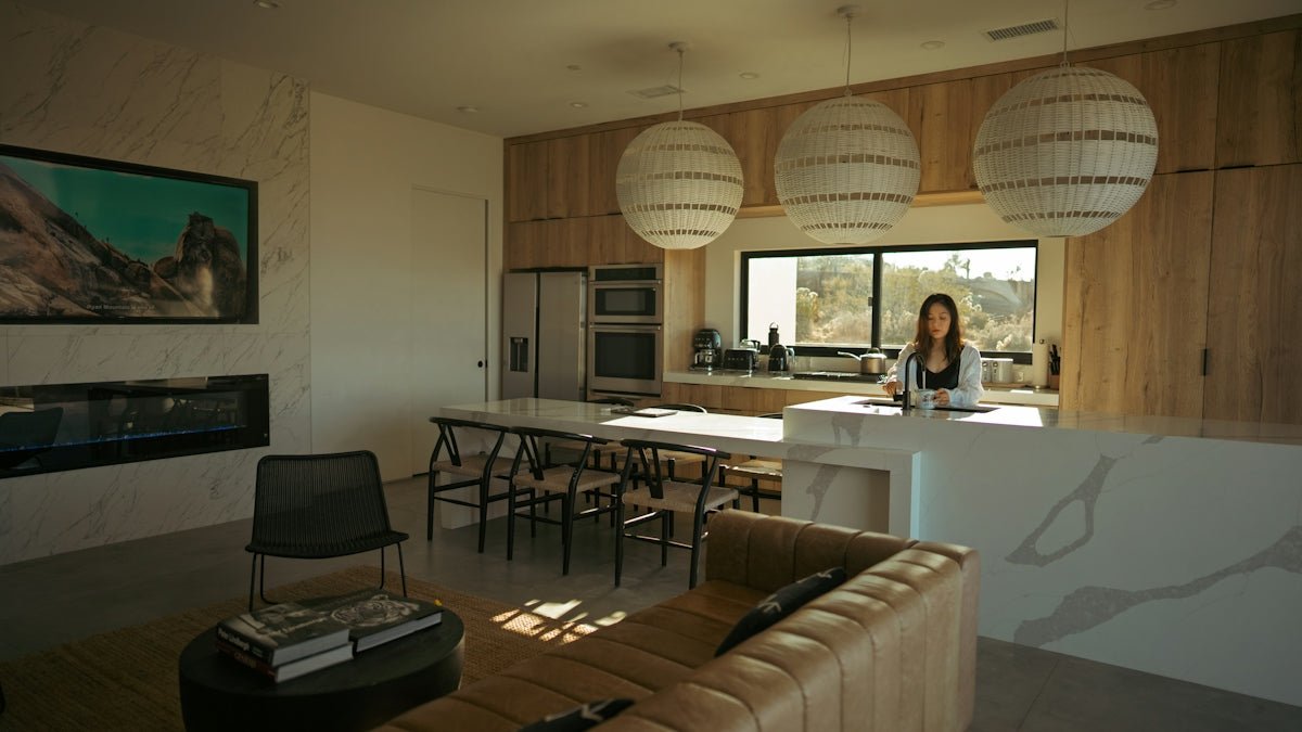 Woman standing in a modern kitchen and living area